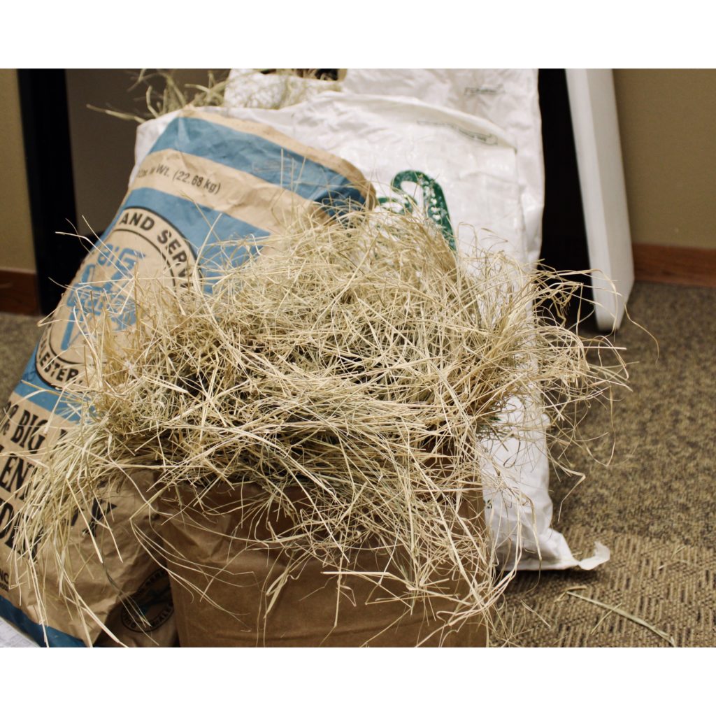 Hay sample spilling out of feed bag.